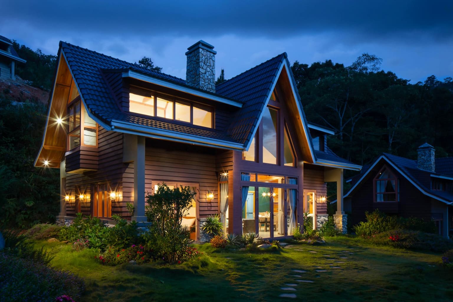 A house with the lights on at dusk